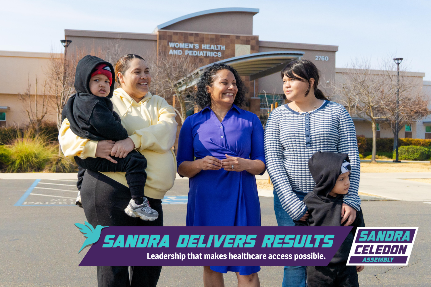 Sandra Celedon stands with two Fresno mothers and their young children outside a Women’s Health and Pediatrics clinic building, smiling and talking in a parking lot on a sunny day.